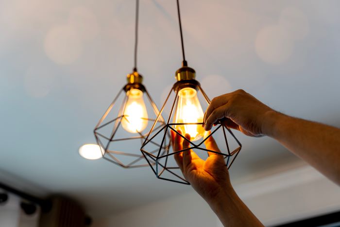 electrician installing light fixture