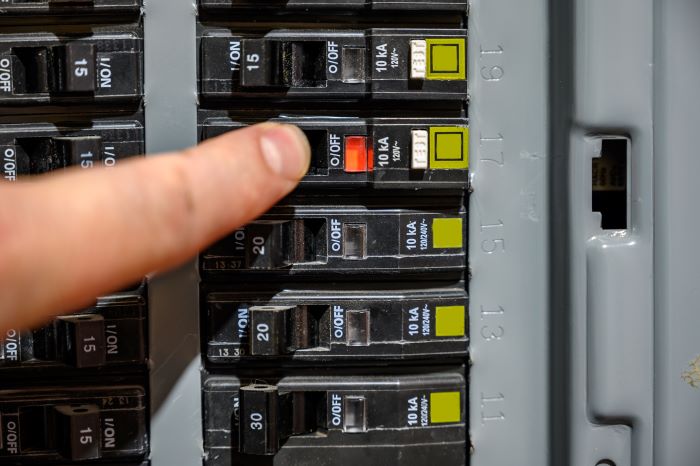 electrician showing tripped breaker